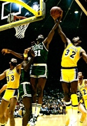 Earvin "Magic" Johnson (on right wearing number 32) battles the Boston Celtics Cedric Maxwell in the 1985 N.B.A. Finals