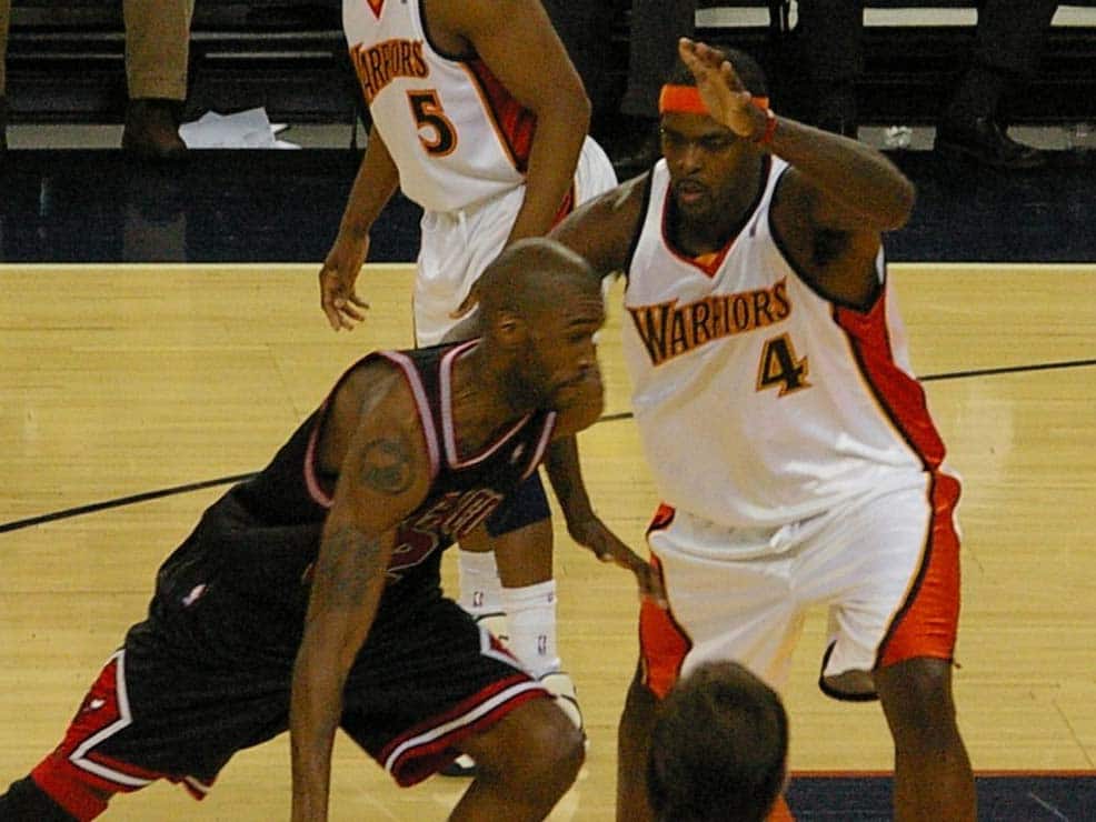 Chris Webber (right, wearing number 4) playing for the Golden State Warriors (circa 2008)